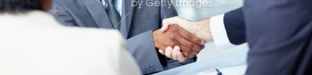 Men in business suits shaking hands