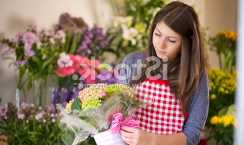 Young trainee working in flower shop